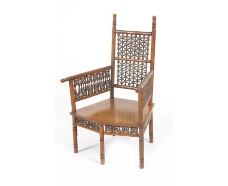 A Liberty &amp; Co Cairene  mahogany armchair,  the angled seat on five turned legs, the arms and back inset with mashrabiya 