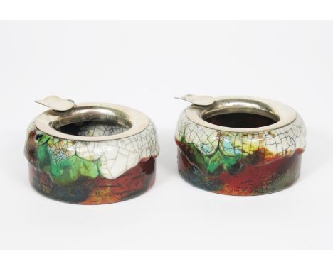 A pair of Royal Doulton Chang ashtrays with silver mounts designed by Charles Noke, by Harry Nixon, circular, shouldered form
