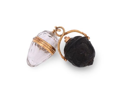 A LATE 18TH CENTURY CARVED NUT PENDANT AND A GLASS HINGED PENDANT  The first carved with a basket of flowers and a dog in a l