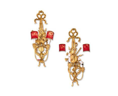 A PAIR OF CARVED GILTWOOD TWIN BRANCH WALL LIGHTS  CIRCA 1900  The backplates carved as ribbon tied swags decorated with musi