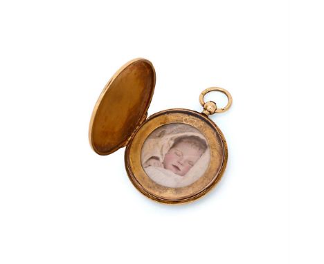 AN EARLY 20TH CENTURY GOLD CIRCULAR LOCKET The engine turned locket opening to a glazed interior with a miniature of a sleepi