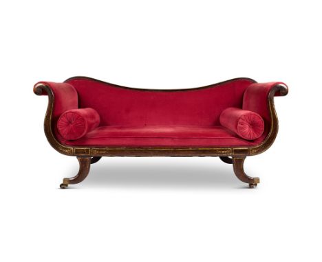 A REGENCY SIMULATED ROSEWOOD AND PARCEL-GILT SOFA CIRCA 1815   With scrolled padded ends, a padded seat and bolsters on sabre