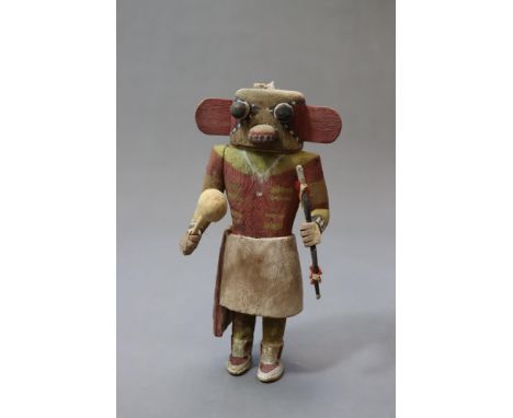 Made of cottonwood, well proportioned, with side sash carved in relief. Carries its bow and rattle. Arms nailed to torso by m