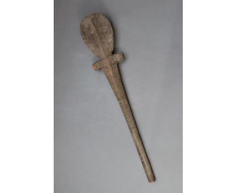 An U'u war club style, carved in heavy hardwood, the double sided top carved to resemble a human face, the shaft with intrica