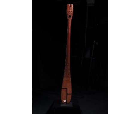 The carving with incised abstract motifs, the top finial with two opposing heads, clan motifs, and geometric designs; with bu