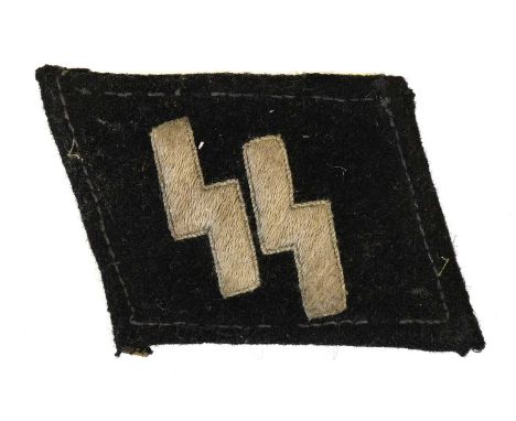 A Second World War German Waffen-SS Man’s Collar Patch, of black felt with machine embroidered pale grey SS runes, removed fr