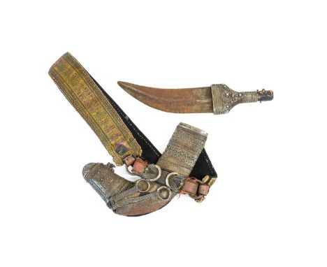 An Early 20th Century Yemeni Jambiya, the 19cm double edge curved steel blade with raised medial ridge, the wood grip and sca