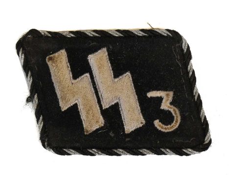 A Second World War German Waffen-SS Man’s Early Type Collar Patch, in black felt with machine embroidered pale grey SS runes 