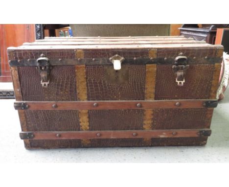 A travelling trunk with label for Bow's Emporium  Glasgow" wood and metal bound with simulated crocodile skin panels  origina