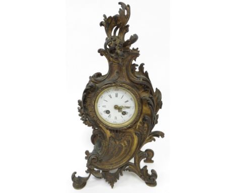 A French gilt mantel clock, with an eight day movement and white enamel dial, on scroll feet