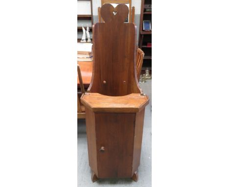 An Arts and Crafts oak child's high chair of pulpit" form  having high back with heart shaped finial; removable hinged tray a