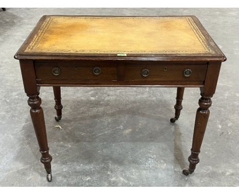 A George IV mahogany writing table, the leather inlet top over two frieze drawers and two false drawers, raised on turned tap