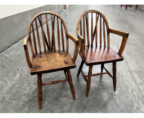 A pair of 19th century country Windsor elbow chairs on splayed ring turned legs. Various woods