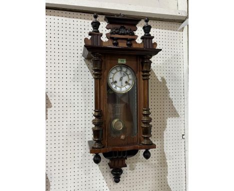 A German Vienna style walnut wall clock with two train movement striking on a coiled gong. 34' high