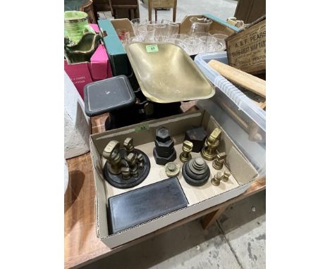 A set of kitchen scales with brass and iron weights