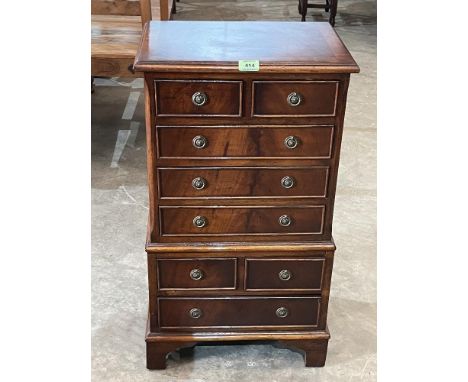 A small mahogany chest of eight drawers on bracket feet. Of recent manufacture. 30' high