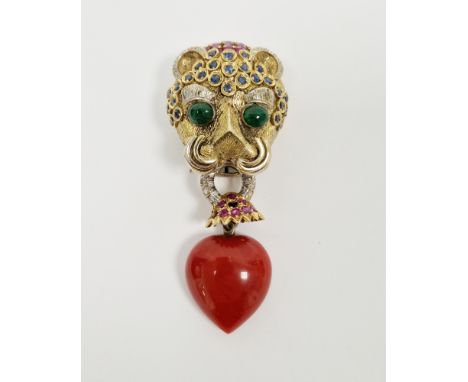 Gem set leopard's head brooch&nbsp;in the style of Cartier, the head surmounted with three rows of pear-shaped rubies, the ea