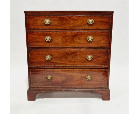 George III mahogany and crossbanded chest&nbsp;of narrow depth, having four long cockbeaded graduated drawers with brass oval