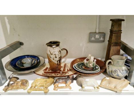 Collection of studio pottery items including an earthenware slip decorated dish, with a peacock on a dark brown slip ground, 