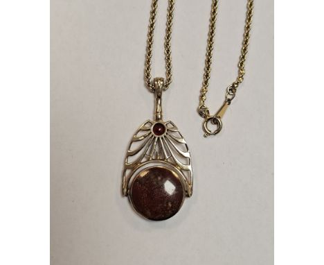 9ct yellow gold spinning fob pendant, held on an openwork mounted set with a faceted red stone, the fob set with a polished j