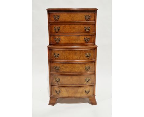 20th century small bowfronted chest on chest&nbsp;in the George III-manner, having seven graduated cockbeaded long drawers wi