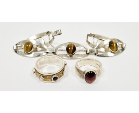 Three items of silver jewellery including five panel bracelet set with five cabochon oval tiger eye stones, oval cabochon gar