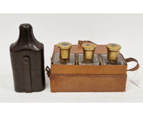 Early 20th century leather cased gentleman's bottle set, the three square glass bottles with gilt metal lids, 14cm high conta