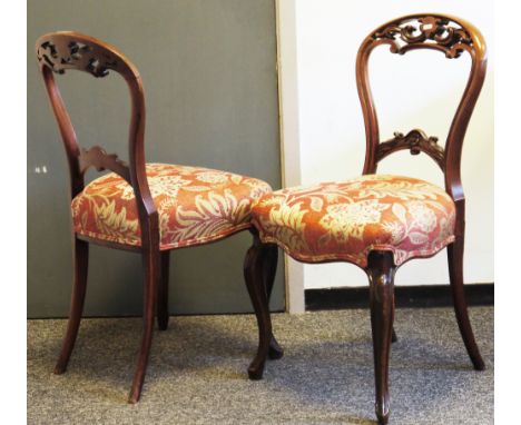 Set of four Victorian mahogany balloonback dining chairs&nbsp;with carved pierced scrolling top rails, stuffover seats, on ca