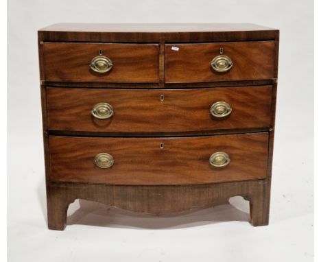 Early 19th century mahogany bowfronted chest, having two short and two long cockbeaded graduating drawers with brass oval dro