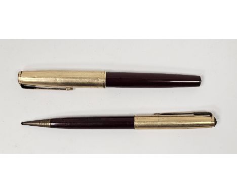 Two vintage Parker pens&nbsp;comprising a red cased fountain pen of gilt metal colour and a pencil similar, both named for A 