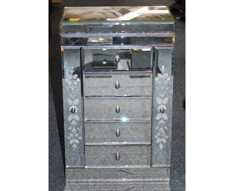 A mirror finish jewellery box, with two tier lifting top, above arrangement of four drawers, with two full length hanging pan