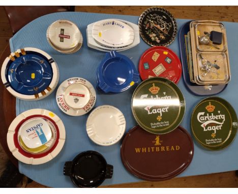 Tinplate pub trays including Carlsberg, Cathay Cocktail and Whitbread, and ceramic ashtrays including Senior Service, Piccadi