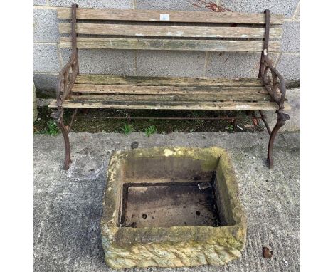 Cast iron framed garden bench along with a faux stone trough planter