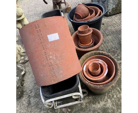 Quantity of terracotta pots along with a wrought iron/plastic trough planter