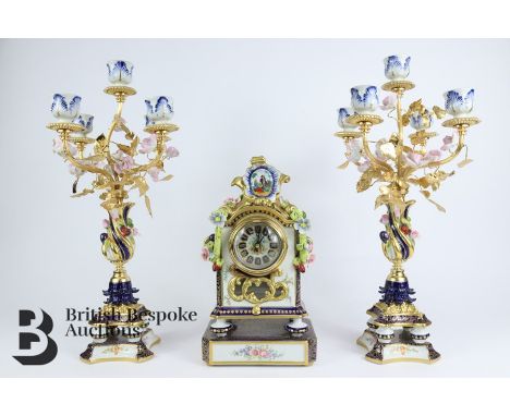 Giulia Mangani porcelain clock and garniture. The clock having applied roses, hops and berry in relief, white enamel face wit