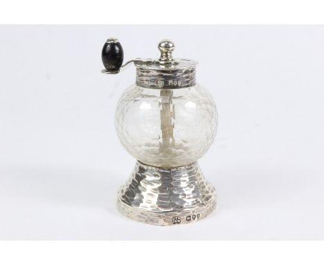 An unusual hammered finish silver pepper grinder, London hallmark dated 1894 mm Hukin & Heath, the design is attributed to Dr