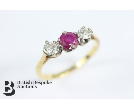 18ct gold and platinum ruby and diamond ring. The ring set with a central ruby approx 4.3mm, flanked by approx 2 x 10 pts of 