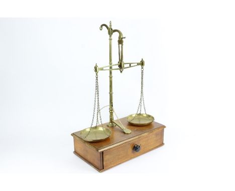 Set of W &amp; T Avery brass scales, surmounted on an oak platform with a single drawer housing a quantity of brass weights, 