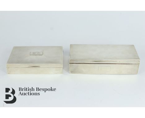 Two silver cigarette boxes; the first hallmarked Birmingham 1964 and measuring w 16cm x d 11cm x h 4cm, and the second hallma