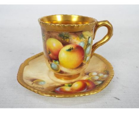 A Royal Worcester, fruit decorated cup and saucer, the saucer decorated with peach and grapes with shaped gilt rim, the cup w