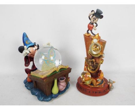 Disney - Two Disney snow globes comprising Fantasia and Disney 100th Year, largest approximately 34 cm (h). [2]Condition Repo