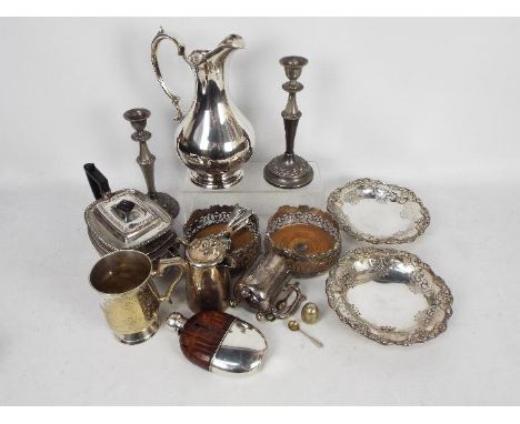 A good collection of silver plated items including a silver plate and brown leather clad hip flask, wine ewer, teapot, bottle