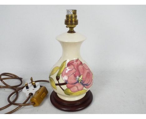 Moorcroft Pottery- a table lamp tubelined and hand painted with pink magnolia on a cream ground, approx 24.5 cm (h) (excludin