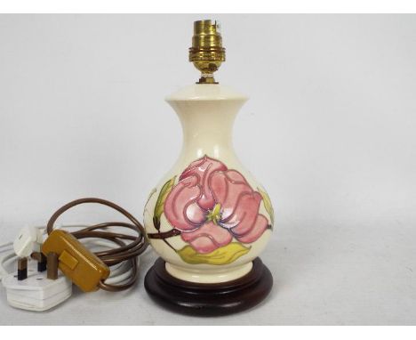 Moorcroft Pottery- a table lamp tubelined and hand painted with pink magnolia on a cream ground, approx 24.5 cm (h) (excludin