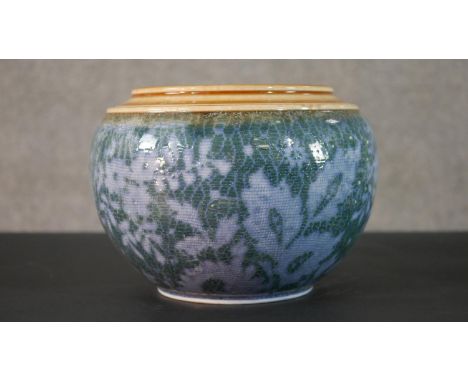 A early 20th century Doulton Lambeth glazed ceramic planter with stylised floral and foliate design. Impressed makers mark to
