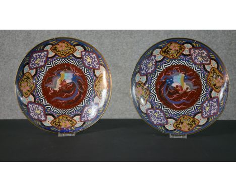 A pair of 19th century Japanese cloisonné enamel phoenix plates, with colourful geometric designs. (enamel damaged and restor