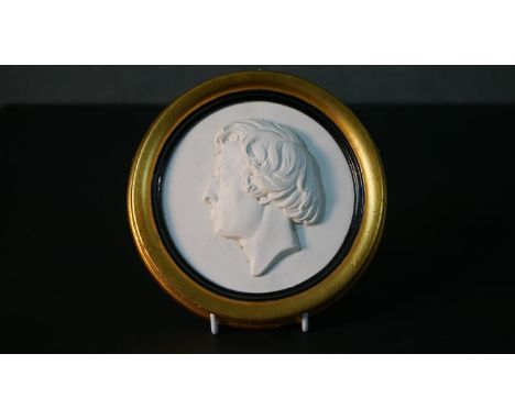A gilt framed 19th century plaster relief plaque with a male portrait. Unsigned. Diam.16cm 