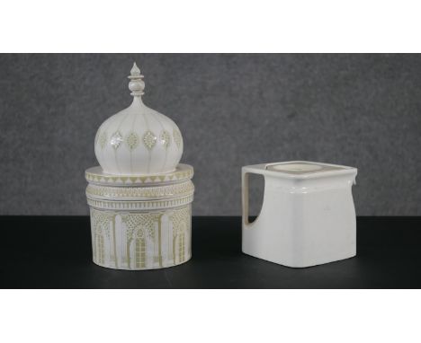A ceramic biscuit tin in the form of Royal Pavilion, Brighton along with a Great Western Railway Grimwade white ceramic cube 