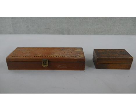 An early 20th century games box, dominoes, cards and a cribbage set along with a marquetry design folding cribbage board. H.6