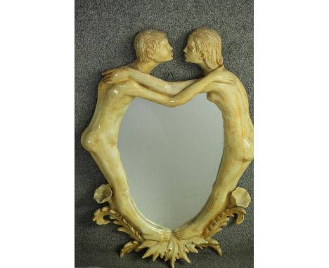 A ceramic framed wall mirror of two figures embracing in a kiss. Signed A. Gambaretto, label verso. H.73 W.52cm. 